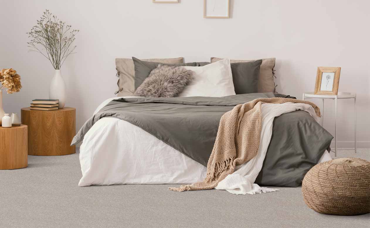 Bedroom with bed, grey carpeted floor